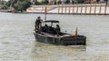 Armed soldiers aboard light boat during military operation in the city river