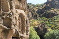 Armenia, Geghard, September 2021. Crosses on the wall of the cave temple and the surrounding nature.