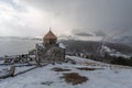 Armenia, Lake Sevan - January 9, 2026: Stone church of Sevanavank Monastery stands on snowy plateau above lake, dark Royalty Free Stock Photo