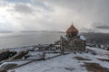 Armenia, Lake Sevan - January 9, 2026: Stone church of Sevanavank Monastery stands on snowy plateau above lake, dark Royalty Free Stock Photo