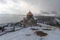 Armenia, Lake Sevan - January 9, 2026: Stone church of Sevanavank Monastery stands on snowy plateau above lake, dark Royalty Free Stock Photo