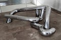 Armenia, Yerevan, September 2021. Interlacing of chrome-plated metal pipes as an art object in a gallery of contemporary art.