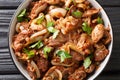 Armenian cuisine recipe chicken liver, heart and stomachs with onions, tomatoes and spices close-up in a bowl. horizontal top view