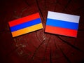 Armenian flag with Russian flag on a tree stump Royalty Free Stock Photo