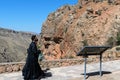 Armenia, Noravank, September 2022. Armenian priest with a child against the backdrop of mountains in the monastery.