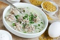 Armenian white sour soup with meatballs, bulgur and green parsley