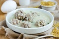 Armenian white sour soup with meatballs, bulgur and green parsley