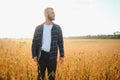 armer inspects soybeans before harvesting. The concept of agricultural industry