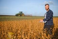 armer inspects soybeans before harvesting. The concept of agricultural industry