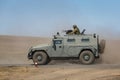 Armored car GAZ-233014 Tiger with a machine gunner upstairs quickly goes on a military training ground