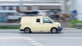 Armored encashment truck Volkswagen Transporter is driving in the city street