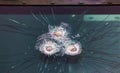 Armored glass after of a direct hit from an automatic weapon. Safety glass after being hit by a bullet. Bulletproof