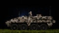 Armored personnel carrier infantry fighting vehicle, armored vehicle at night in the field, camouflage coloring of armored