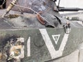 Armoured vehicle damaged by a shell. A trace from a shell hitting an armored personnel carrier. Detail of Russian military