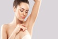 Armpit epilation, lacer hair removal. Young woman holding her arms up and showing clean underarms Royalty Free Stock Photo