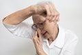 Armpit smelly or the body odor foul,annoyed asian senior woman sniffing her armpit,smelling something stinks,body stench and sweat