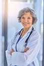 Arms crossed, doctor and portrait with mature woman in hospital for healthcare or trust. Cardiology, smile for medical Royalty Free Stock Photo