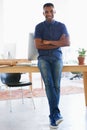 Arms crossed, smile and portrait of man by desk in office for vision, web design or startup company. Happy, confident Royalty Free Stock Photo