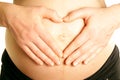 Arms on pregnant mommy belly tummy heart shape Royalty Free Stock Photo