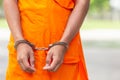 Arms of Thai monk with metal silver handcuff. Arrest the monk or Royalty Free Stock Photo