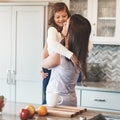 These arms were made for hugging. a happy mother hugging her cute little girl in the kitchen at home. Royalty Free Stock Photo