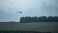 Army attack helicopter flying low over the countryside Royalty Free Stock Photo