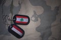 army blank, dog tag with flag of lebanon and yemen on the khaki texture background.