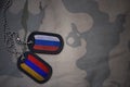 army blank, dog tag with flag of russia and armenia on the khaki texture background