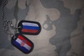 army blank, dog tag with flag of russia and croatia on the khaki texture background.