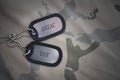 Army blank, dog tag with text anzac day on the khaki texture background. Royalty Free Stock Photo