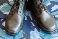 Army boots and army belt on blue camouflage fabric. Overalls for the soldier