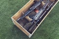 Army box ammunition with AK47 rifle and ammunition. An automatic weapon with a sniper scope in wood box Royalty Free Stock Photo