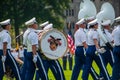 Army cadet West Point marching band marching on the parade grounds. A cadet carrying a large drum drum and one with a white tuba