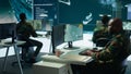 Army intelligence specialists using advanced computer systems and satellite data Royalty Free Stock Photo