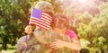 Army man hugging daughter with American flag Royalty Free Stock Photo