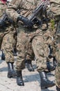 Army parade - armed soldiers in camouflage military uniform are marching