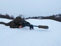 Army sniper looking through the scope. Snipers images. The sniper lies and aims through the telescopic sight. Sniper Rifle with ma