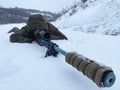 Army sniper looking through the scope. Snipers images. The sniper lies and aims through the telescopic sight. Sniper Rifle with ma