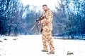 Army sniper during military operation using a professional rifle on a cold winter day