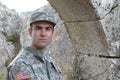 Army soldier in front of a country in ruins