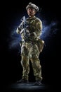 Army soldier in Protective Combat Uniform holding Special Operations Forces Combat Assault Rifle on dark background Royalty Free Stock Photo