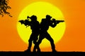 Army soldier with rifle orange sunset silhouette