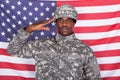 Army soldier saluting in front of american flag Royalty Free Stock Photo