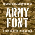 Army stencil alphabet font. Type letters and numbers on distressed camo seamless background. Royalty Free Stock Photo