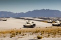 Army tanks maneuver in the white desert sand Royalty Free Stock Photo