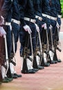 Army uniforms with machine guns in a row. Royalty Free Stock Photo