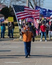 An army veteran wave a flag at a President Donald Trump support rally where anti impeachment chants were numerous Royalty Free Stock Photo