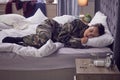 Army woman, pills or depression in bedroom of house, home or hotel and ptsd disorder, trauma or shell shock burnout