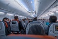 High angle of air passengers with protective masks sitting on their seats in Turkish Airlines flight before flying