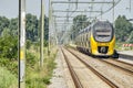 Yellow intercity train leaving station